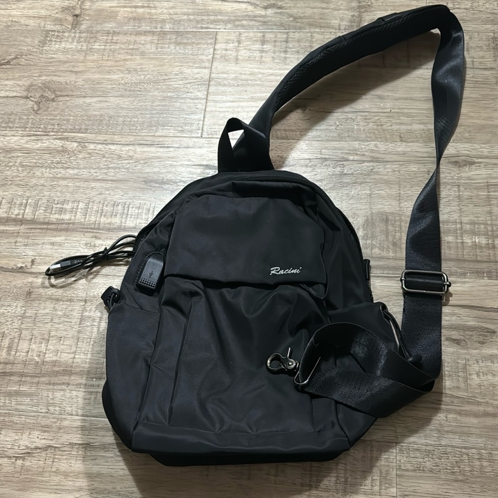 $25 Racini body cross bag, in very good condition, with charging pocket